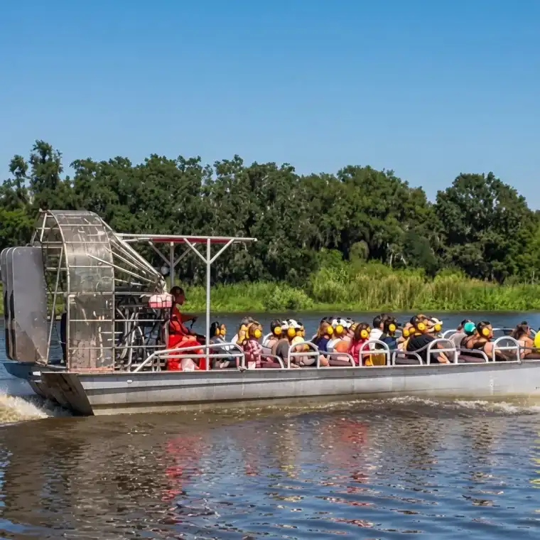 Guests aboard a large airboat in Louisiana wetlands